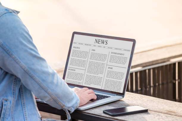 istock A man is working using laptop reading news article on screen at outdoor 1024779186
