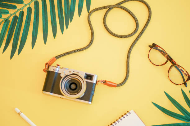istock A camera and glass on the yellow background 1024780664