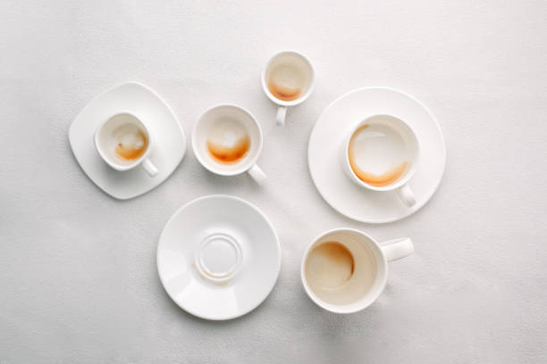 istock Many Empty coffee cups after drink on white background, trendy minimal monochrome concept, lazy sleepy morning closeup 1024789954