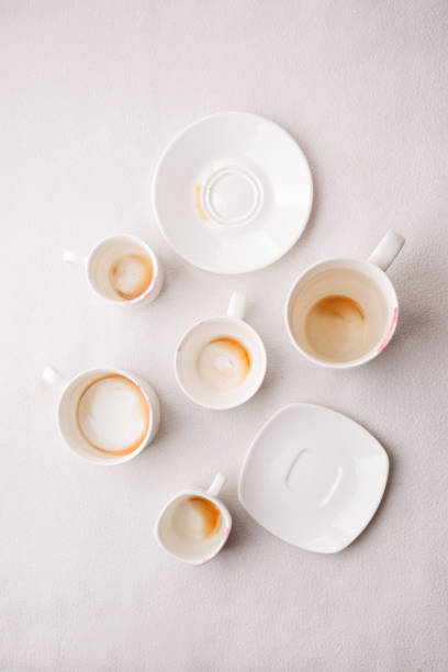 istock Many Empty coffee cups after drink on white background, trendy minimal monochrome concept, lazy sleepy morning closeup 1024789998