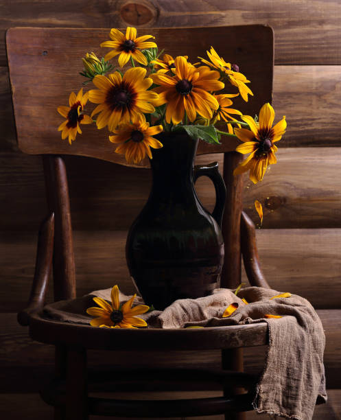istock yellow flowers in a jug on a chair 1024790078