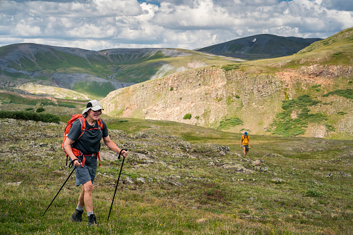 Two men trekking with hiking poles and backpacks, San Juan Mountains, Weminuche Wilderness, Rocky Mountains, Silverton, CO, USA