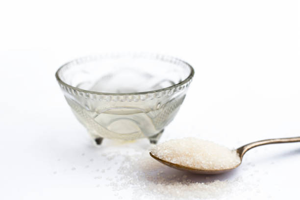 istock Cube sugar or crystallized sugar with its syrup and mint leaves isolated on white with powder or ground sugar. 1024802648