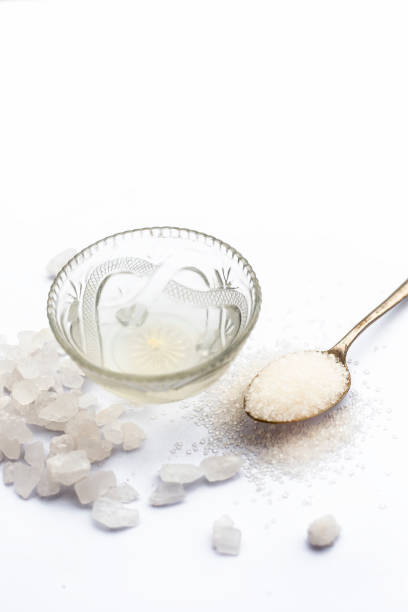 istock Cube sugar or crystallized sugar with its syrup and mint leaves isolated on white with powder or ground sugar. 1024802662