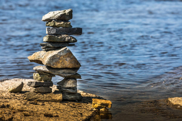 istock Inukshuk by the river edge. 1024805414