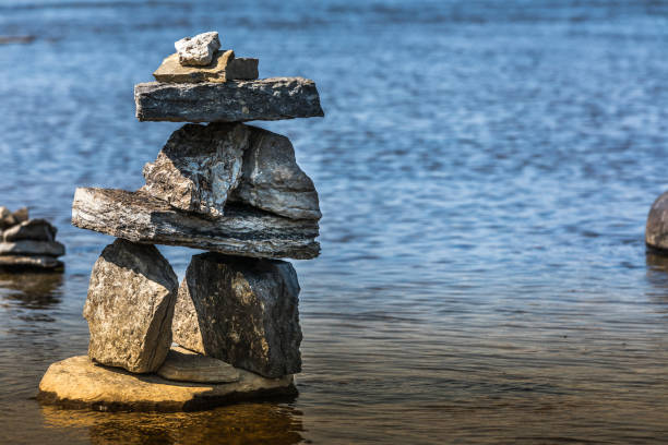 istock Inukshuk by the river edge. 1024805800