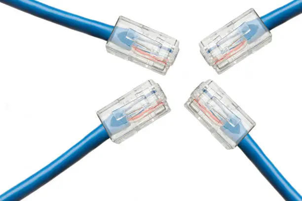 Photo of Four blue Internet cables converge in one point, isolated on white background