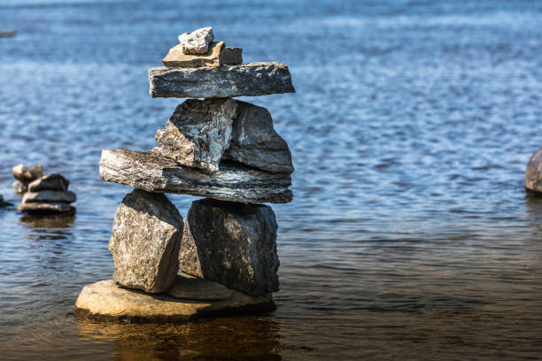 istock Inukshuk by the river edge. 1024805854