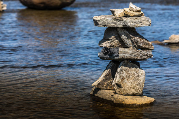 istock Inukshuk by the river edge. 1024805922