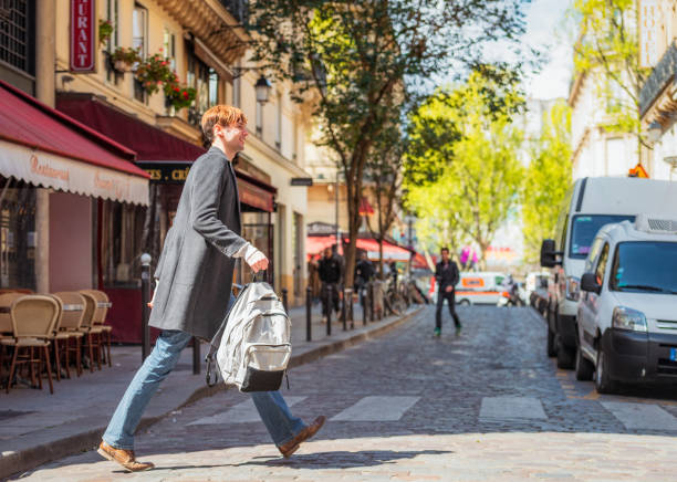 Young man crossing a Paris sidestreet