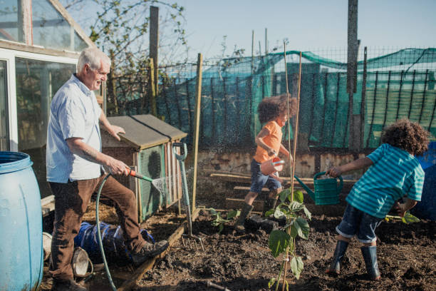 istock Water Fight at Grandad's Allotment 1024810830
