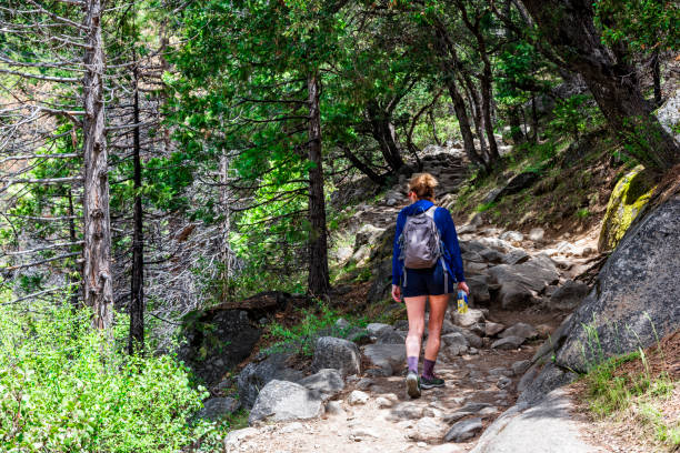 Young woman walking alone on the path in Yosemite