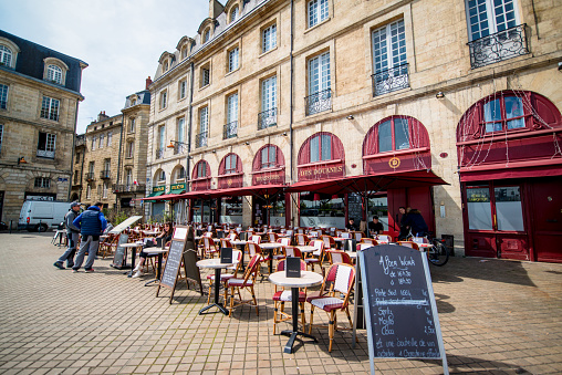 Bordeaux, France - May 02, 2018: Cafes and restaurants on Bordeaux streets, France. People walking and relaxing in restaurant