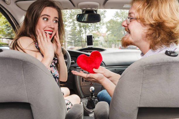 istock Man giving gift in car to her girlfriend 1024828180