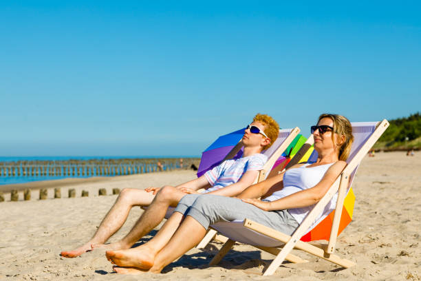 istock Woman and man relaxing on beach 1024828890