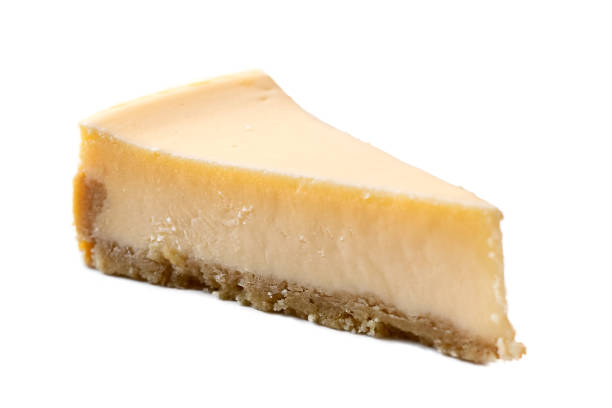 A slice of plain baked cheesecake isolated on white.