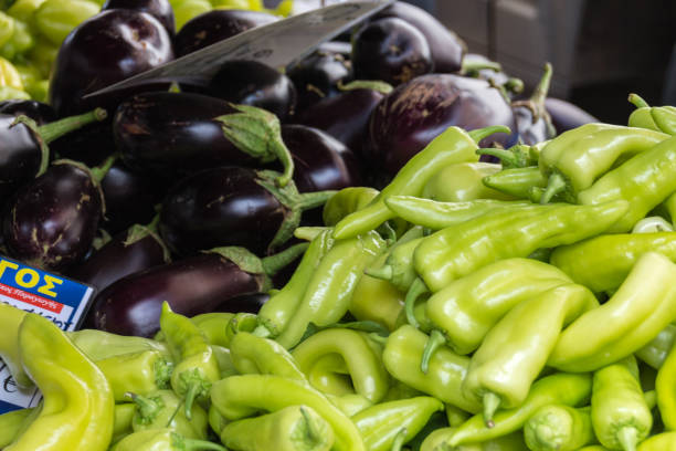 Closeup of purple eggplants and green pepper at a market stand in Halkidiki