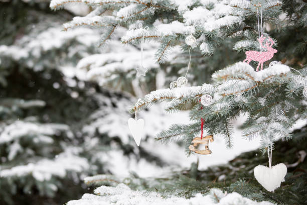 istock Nice decorations on a Christmas tree with snow outdoors. Celebration, winter and holidays concept 1024842682