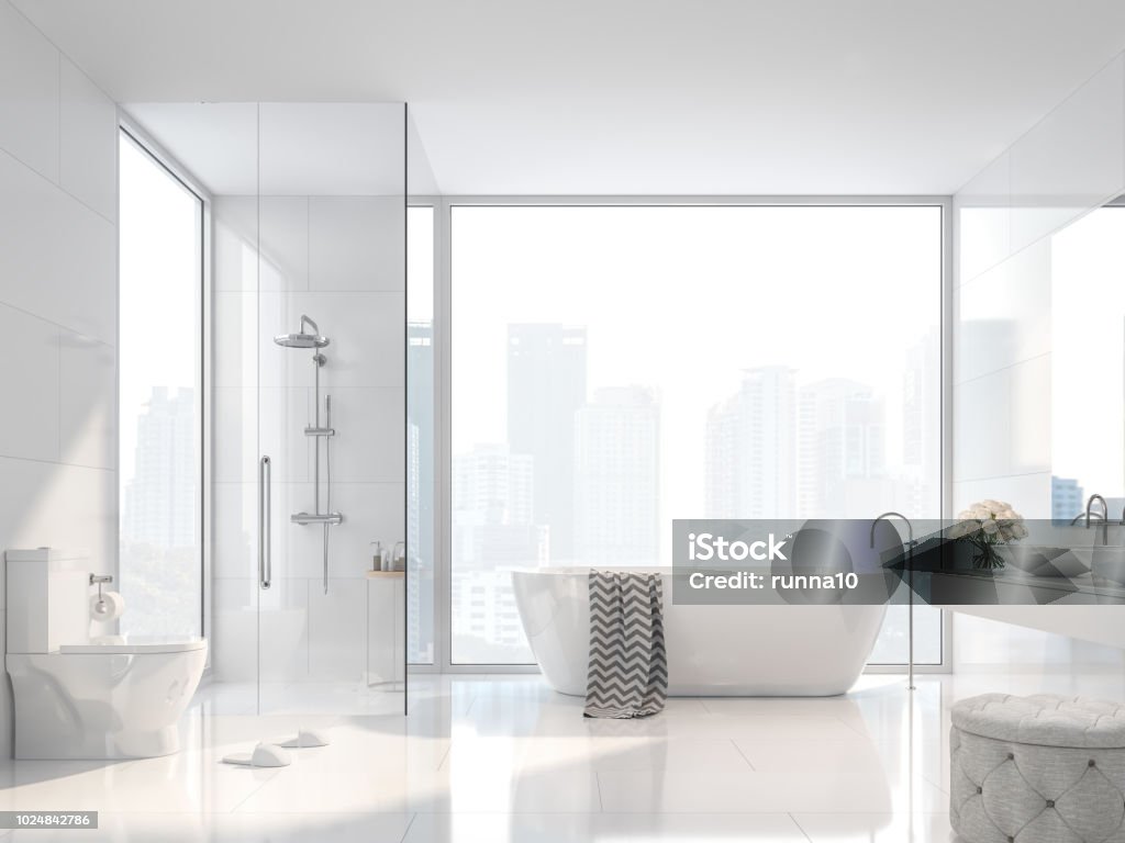 Modern white bathroom with city view 3d render Modern white bathroom with city view 3d render. There are white tile wall and floor.The room has large windows.Sunlight shines into the room. Bathroom Stock Photo