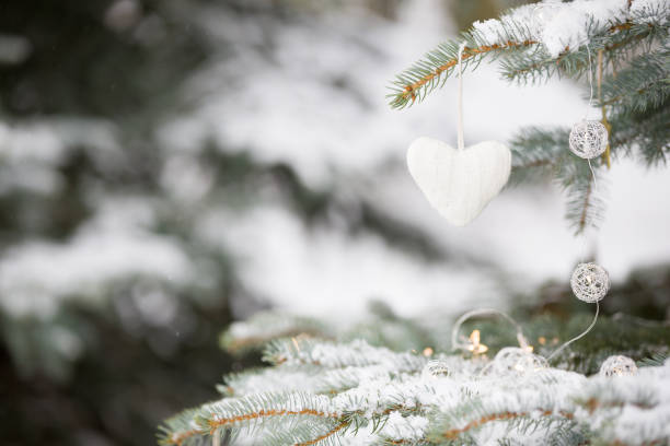 istock Nice decorations on a Christmas tree with snow outdoors. Celebration, winter and holidays concept 1024843906
