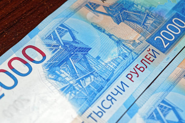 istock Russian two thousandth notes close-up against the background of a dark wooden table 1024859990