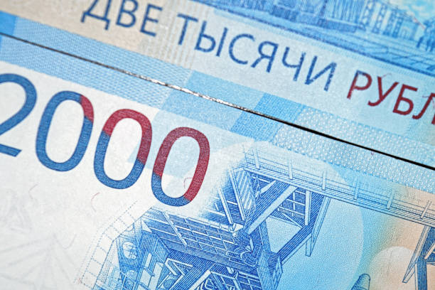 istock Russian two thousandth notes close-up against the background of a dark wooden table 1024860074