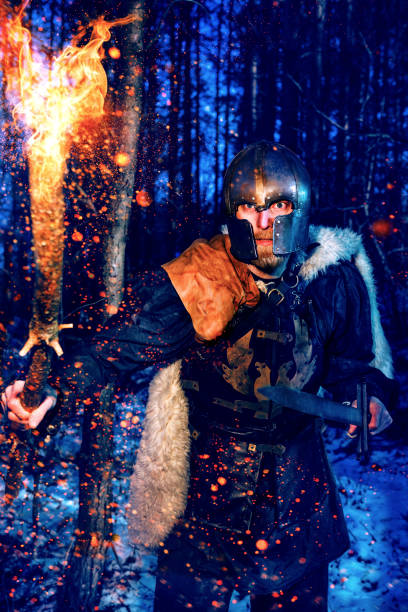 istock Viking holds a flaming torch and sword while on a mission 1024862690
