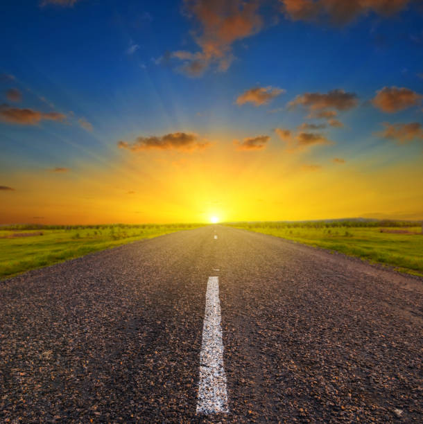 istock asphalt road among a green prairie at the sunset 1024863344