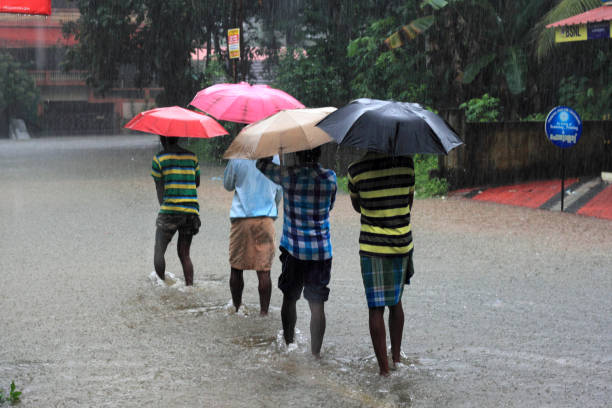 Scenes from the flood affected state of Kerala in India Pathanamthitta, India - August 16,2018:Unidentified people walk through the flooded roads in Pathanamthitta,Kerala, India. Kerala was badly affected by the floods during the monsoon season heavy rainfall stock pictures, royalty-free photos & images
