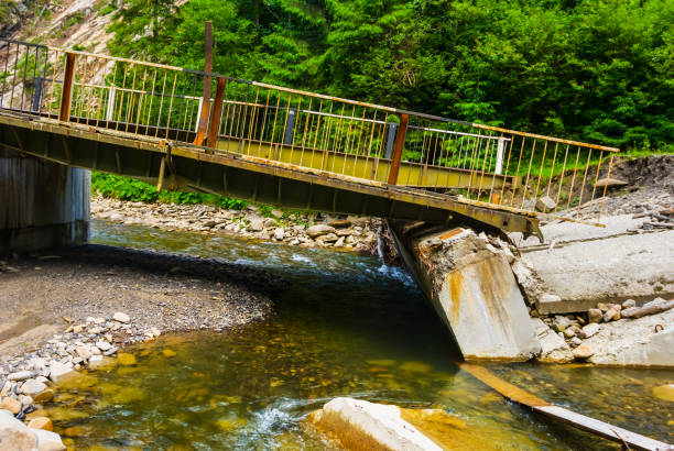 istock old broken bridge over the mountain river, natural calamity 1024863600