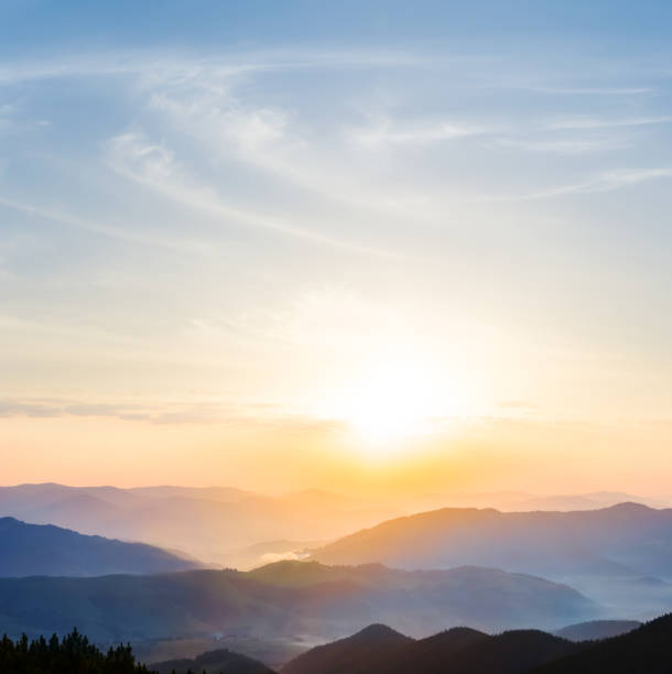 beautiful quiet sunset among the mountain valley with blue mist