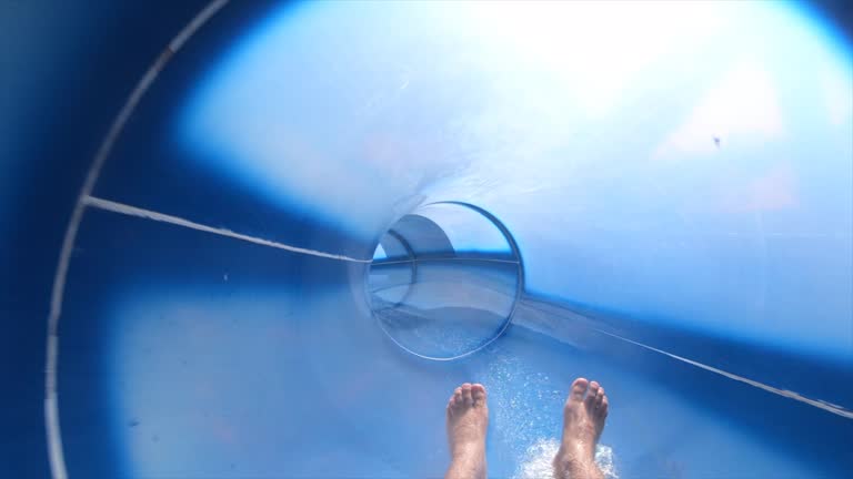 Man having fun and sliding down in a water slide