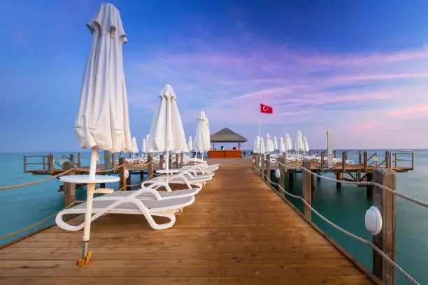 Photo of Beautiful scenery with wooden pier on Turkish Riviera at sunset, Side