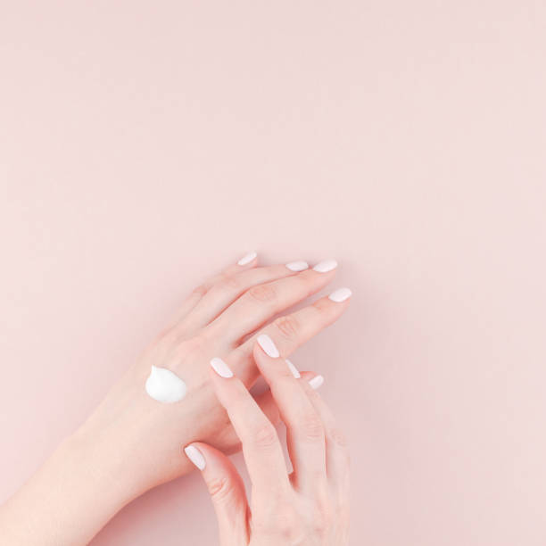 istock Woman moisturizing her hand with cosmetic cream 1024897668