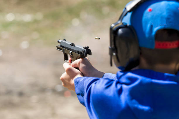 istock Closeup of boy shooting a pistol. 1024898020