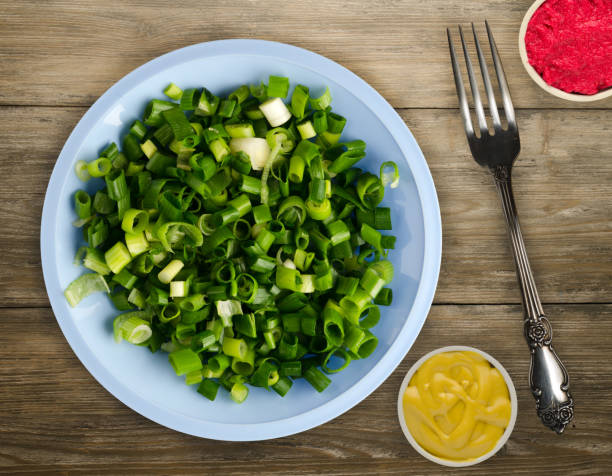 istock onion  on a plate on a wooden background. 1024900112