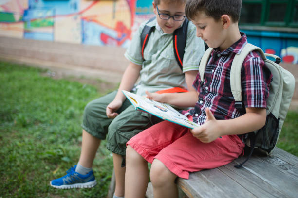 istock Boys read a book in a school yard 1024918880