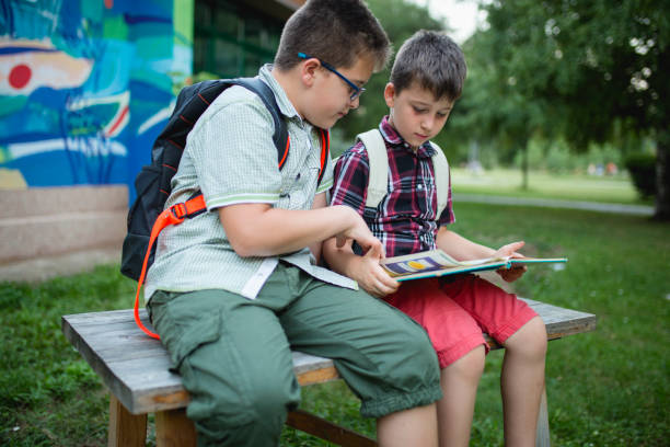 istock Boys read a book in a school yard 1024924874