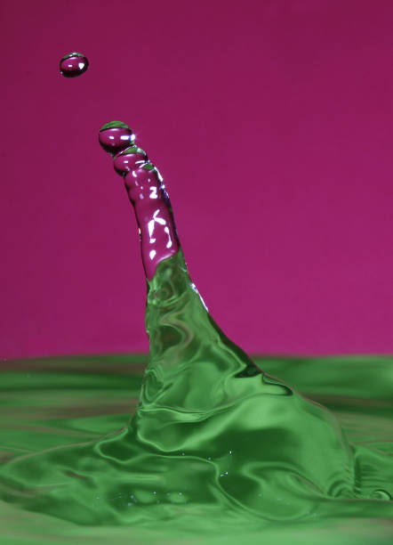 istock splash resulting from the impact of a drop with a container filled with water, freezing a fraction of a second 1024926628