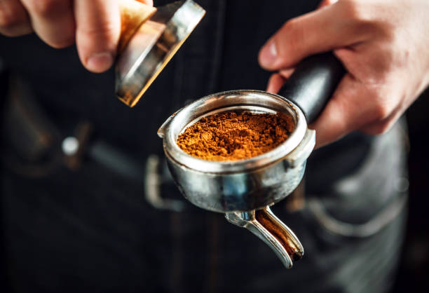 barista holding portafilter and coffee tamper. - tamper imagens e fotografias de stock