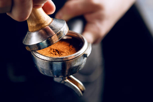 istock Barista holding portafilter and coffee tamper. 1024934056
