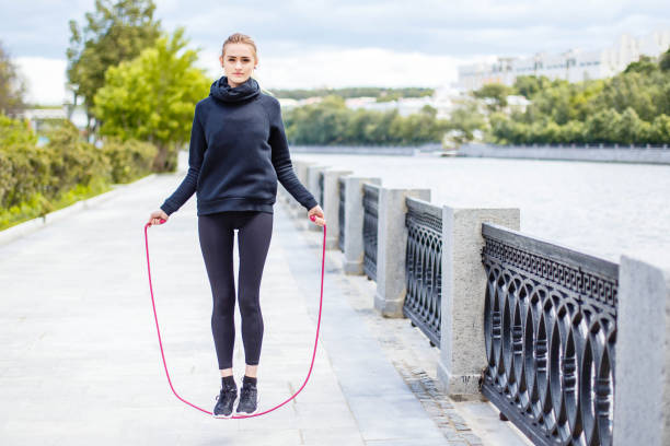 istock Sporty woman warming up with jump rope outdoors. 1024934708