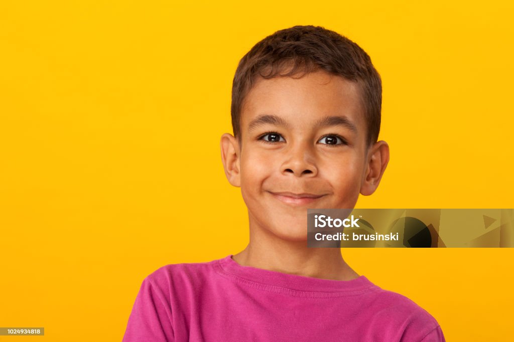 studio portrait of a 10 year old schoolboy on a yellow background Child Stock Photo