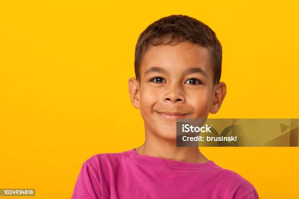 Studio Portrait Of A 10 Year Old Schoolboy On A Yellow Background Stock Photo - Download Image Now