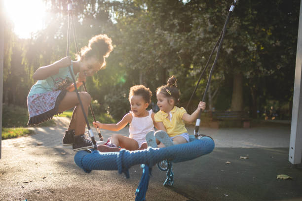 istock Cheerful children swinging on a swing 1024940136