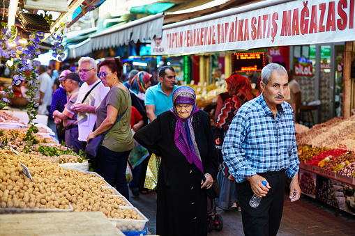 Scenes from everyday street life in Turkey. Old couple looking for goods on street market stall