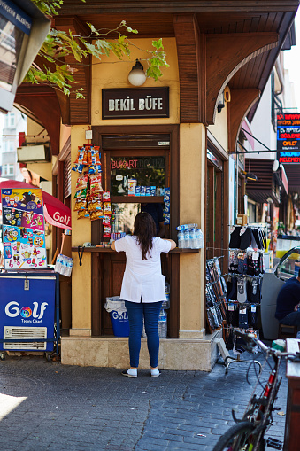 Scenes from everyday street life in Turkey. Woman buying something from a shop
