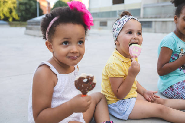 istock Cute and messy siblings eating ice cream in summer 1024942092