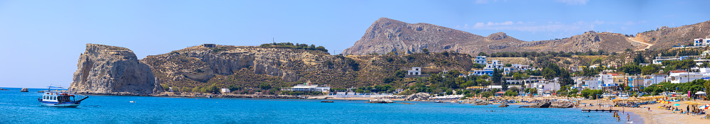 Stegna, Rhodes, Greece - June 21, 2018: Rhodes Greece beach morning panorama. People on the beach.