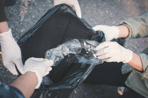 istock High Angle View Cropped Hands Collecting Waste On Road 1024947858